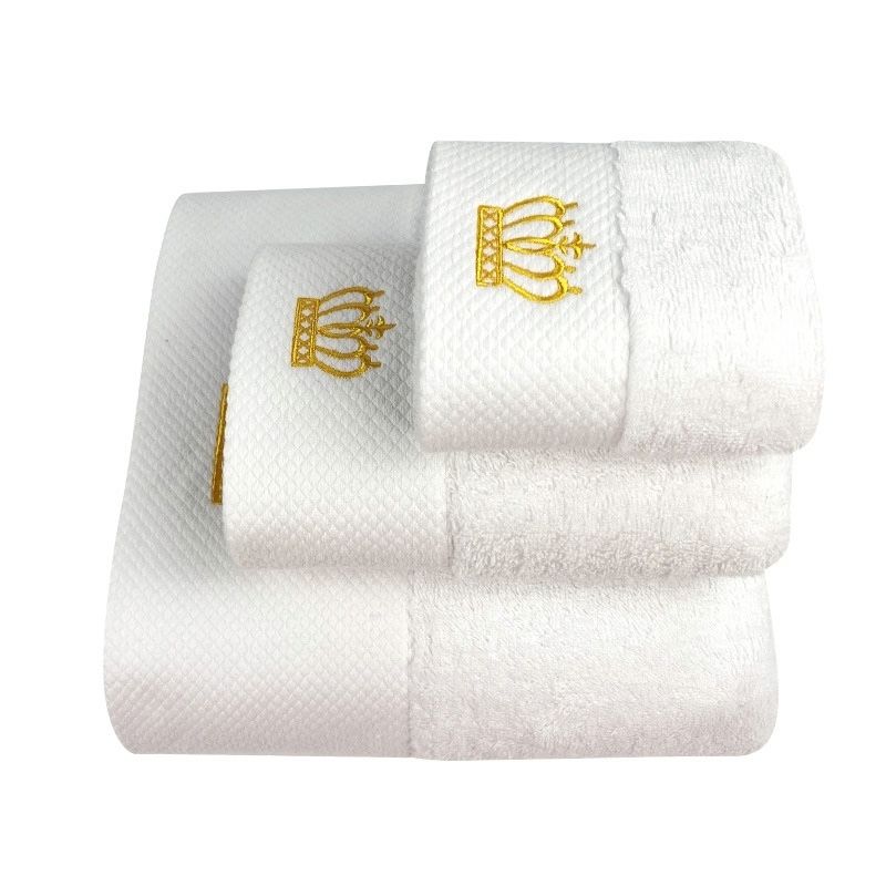White hand and bath towels with gold embroidered crown